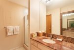 The full, remolded guest bathroom features a shower, sink and washer and dryer